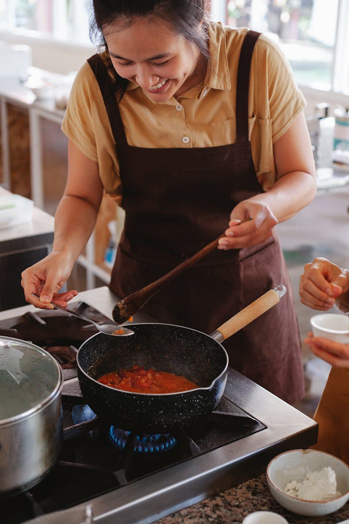 embark Chef cooking with joy while preparing a delicious meal in a modern kitchen.